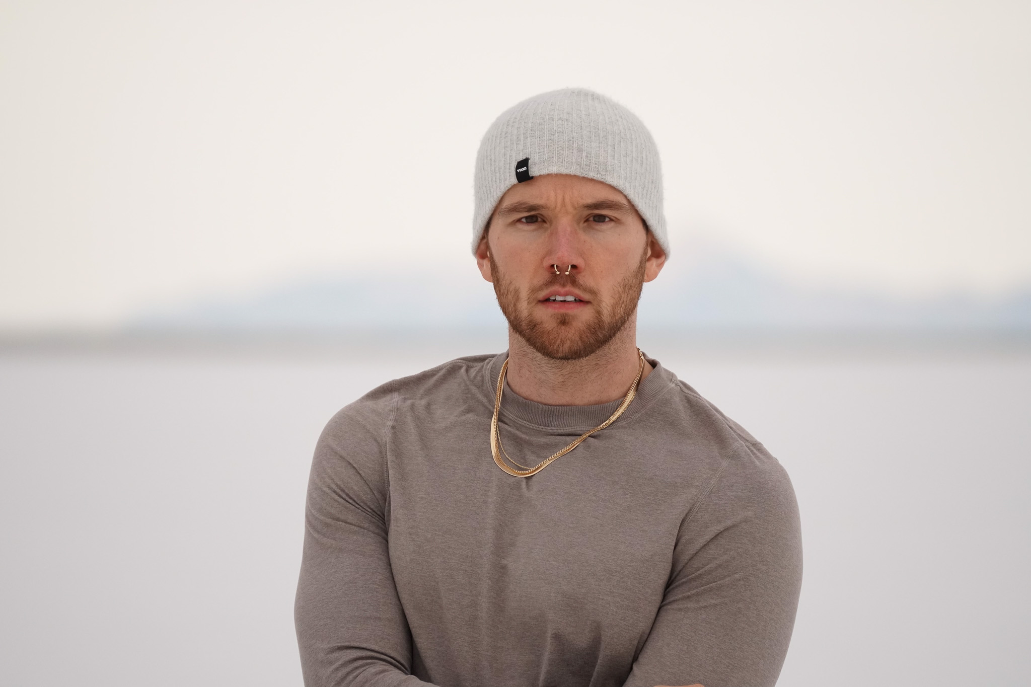 Steven in a beanie and long sleeve, snow in the background.